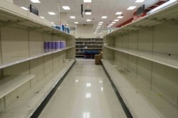 Shelves stand emptied by customers at a local retail store, Monday, March 16, 2020 in New York. New York state entered a new phase in the coronavirus pandemic Monday with all of New York City's public schools closed. (AP Photo/Yuki Iwamura)