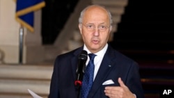 France's Laurent Fabius speaks to reporters after meeting iin Paris with his fellow foreign ministers from Russia, Ukraine and Germany to discuss the Ukraine peace deal, Feb. 24, 2015.