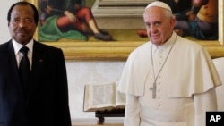FILE - Pope Francis poses with Cameroon President Paul Biya and his wife Chantal Biya during a private audience at the Vatican, Oct. 18, 2013.