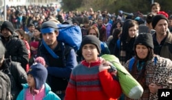 FILE - Migrants are seen walking towards Austria in Sentilj, Slovenia, Oct. 30, 2015.