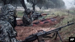 Syrian rebels fighting against President Bashar al-Assad's government take up positions near the town of Taftanaz, January 6, 2013.