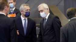 NATO Secretary-General Jens Stoltenberg chats with Russian Deputy Foreign Minister Alexander Grushko ahead of the NATO-Russia Council at the alliance's headquarters in Brussels, Belgium, Jan. 12, 2022.