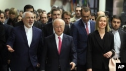 Iranian Foreign Minister Mohammad Javad Zarif, left, Director General of the International Atomic Energy Agency, IAEA, Yukiya Amano of Japan and European Union High Representative Federica Mogherini, right, arrive at the International Atomic Energy Agency