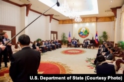 U.S. Secretary of State John Kerry speaks to Laotian Prime Minister Thongsing Thammavong during the outset of a bilateral meeting at the Government House in Vientiane, Laos, Jan. 25, 2016.