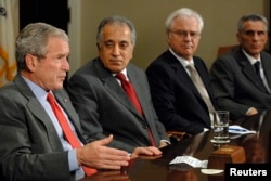 U.S. President George W. Bush sits in on a National Security meeting of ambassadors to the United Nations Security Council, including (2nd L-R) U.S. Ambassador Zalmay Khalilzad, Russia's Ambassador Vitaly Churkin and Italy's Ambassador Marcello Spatafora, to discuss U.S. priorities before the UN, at the White House in Washington, June 25, 2008.
