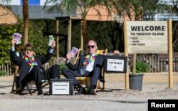 FILE - Activists take part in a demonstration outside the European Commission (EC) headquarters ahead of statements by the EC on the effectiveness of existing measures against tax evasion and money-laundering in light of the recent Panama Paper revelations, in Brussels, Belgium.