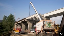 FILE - Construction work is in progress at a new international trade route which part of a sprawling Chinese initiative to build a 'new Silk Road' of ports, railways, and roads to expand trade Asia, Africa and Europe, near Havalian Pakistan, May 11, 2017.