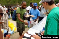Eagle scout hands out socks in Philadelphia.