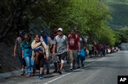 Honduras migrants walk to the U.S as they approach Zacapa, about 70 miles northeast of Guatemala City, Oct. 24, 2018.