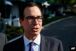 FILE - Treasury Secretary Steve Mnuchin talks with reporters outside the White House, May 21, 2018, in Washington.