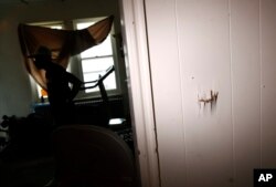 FILE - This July 27, 2017 photo shows damage to a wall from a bullet's exit path in the living room of William Rollins V and his wife, Maria Williams, in Wilmington, Delaware, the day after the home came under gunfire.