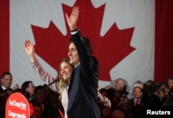 Liberal Party leader Justin Trudeau waves while accompanied by his wife, Sophie Gregoire, as he gives his victory speech after Canada's federal election in Montreal, Quebec, Oct. 19, 2015.