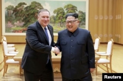 North Korean leader Kim Jong Un shakes hands with U.S. Secretary of State Mike Pompeo, May 9, 2018, released by North Korea's Korean Central News Agency (KCNA) in Pyongyang.