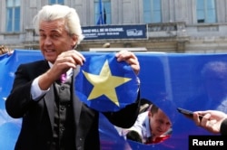 FILE - Dutch far-right Freedom Party leader Geert Wilders holds a star he cut from a European Union flag during a Eurosceptic rally in front of the EU Parliament in Brussels, Belgium, May 20, 2014.