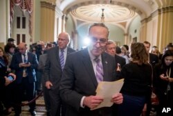 Senate Minority Leader Sen. Chuck Schumer of N.Y., center, and Sen. Patrick Leahy, D-Vt., center left, leave a new conference after House and Senate negotiators worked out a border security compromise hoping to avoid another government shutdown on Capitol Hill, Feb. 12, 2019, in Washington.
