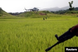 A Myanmar army helicopter transports journalists to an area were government forces found the bodies of Hindu villagers, whom authorities suspect were killed by insurgents last month, in a mass grave near Maungdaw in the north of Myanmar's Rakhine state, Sept. 27, 2107.