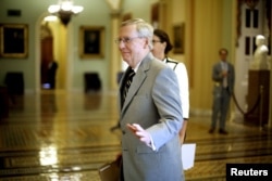 U.S. Senate Majority Leader Mitch McConnell, R-Ky., greets staff members at the U.S. Capitol in Washington, Sept. 8, 2015. Three more Democratic senators announced they would back the Iran nuclear deal.