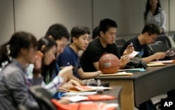 FILE - Chinese students attend a new-student orientation at the University of Texas at Dallas in Richardson, Texas, Aug. 22, 2015.