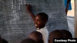 A young boy during a lesson at the Mugosi Primary School, which caters mostly for children of the Kahe refugee camp in the town of Kitschoro, in northeastern Democratic Republic of the Congo. (UNESCO/M.Hofer)