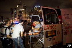 A wounded man is evacuated from the scene of a stabbing attack in Jaffa, a mixed Jewish-Arab part of Tel Aviv, Israel, March 8, 2016.