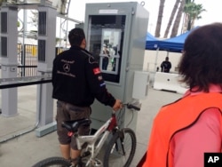 Ramon Rangel, 29, a Tijuana truck driver, stands at a machine that captured images of his iris and facial features to verify his documents while leaving San Diego on his way to Mexico, Feb. 18, 2016. The U.S. government uses eye scans and facial recognition technology on foreigners leaving the U.S. on foot at a busy San Diego crossing with Mexico.
