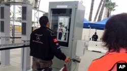 A Tijuana truck driver stands at a machine that captured images of his iris and facial features to verify his documents while leaving San Diego on his way to Mexico, Feb. 18, 2016.