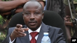 FILE - M23 rebel leader Bishop Jean-Marie Runiga, addressing a press conference, Bunagana, Congo, Jan. 3, 2013.