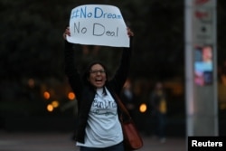 A small group of demonstrators block traffic to demand action by the federal government on the Deferred Action for Childhood Arrivals (DACA) in downtown San Diego, California, Dec. 4, 2017.