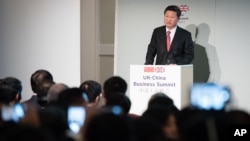 FILE - China's President Xi Jinping addresses participants of the UK-China Business Summit in Mansion House, London, Oct. 21, 2015. Britain will be China's "partner of choice" in the West, Prime Minister David Cameron declared as part of meetings with Xi.