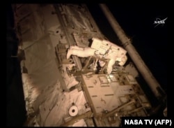 FILE - Astronaut Scott Kelly makes an inspection on the International Space Station, Nov. 6, 2015.