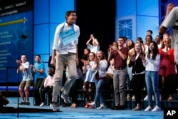 Christopher Serrao, 13, of Whitehouse Station, N.J., celebrates after becoming one of eight co-champions in the finals of the Scripps National Spelling Bee, Friday, May 31, 2019, in Oxon Hill, Md. (AP Photo/Patrick Semansky)