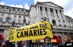 Climate change activists demonstrate opposite the Bank of England in the financial district in London, April 25, 2019, during environmental protests by the Extinction Rebellion group.