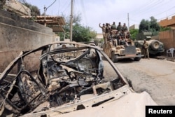 Members of Iraqi rapid response force ride in a military vehicle during a battle against Islamic State militants in Mosul, Iraq, May 20, 2017.