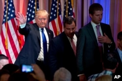 FILE - Republican presidential candidate Donald Trump, accompanied by New Jersey Gov. Chris Christie, center, and his son Eric Trump, right, Jan. 3, 2016.