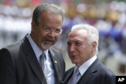 Brazil's President Michel Temer, right, talks with Defense Minister Raul Jungmann during his arrival to attend a meeting of the Defense Military Council, in Brasilia, Brazil, Feb. 22, 2018.