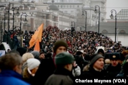 FILE - Russians rally protesting the results of parliamentary elections, in Bolotnaya Square, outside the Kremlin, Moscow, Dec. 10, 2011.