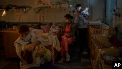 Hospital staff take care of orphaned children at the children's regional hospital maternity ward in Kherson, southern Ukraine, Tuesday, Nov. 22, 2022.