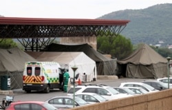 FILE - An ambulance is parked near tents erected at the parking lot of the Steve Biko Academic Hospital, amid a nationwide coronavirus disease (COVID-19) lockdown, in Pretoria, South Africa, Jan. 11, 2021.