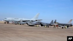 FILE - Turkish, right, and German, left, airmen stand in front of military planes at the Incirlik Air Base near Adana, Turkey, Dec. 15, 2015.