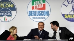FILE - From left, Brothers of Italy's Giorgia Meloni, Forza Italia's Silvio Berlusconi, and the League's Matteo Salvini attend a media event for center-right leaders ahead of the March 4 general elections, in Rome, Italy, March 1, 2018. 