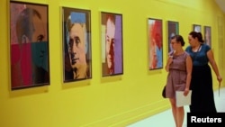 Visitors at Pera Museum in Istanbul look at artwork by Andy Warhol, June 10, 2014.