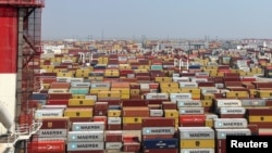 FILE - Containers sit at a terminal at the Yangshan deepwater port, in Shanghai, China, Oct. 10, 2024.