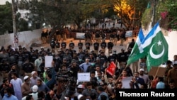 People protest against cartoon publications of Prophet Mohammad in France and Macron's comments, in Karachi, Pakistan, Oct. 30, 2020.