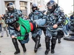 FILE - Police detain a man during a protest in Moscow, Russia, Aug. 10, 2019.