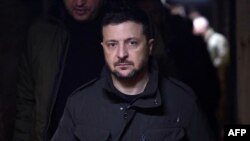 This handout photograph taken and released by Ukrainian Presidential Press Service on December 12, 2024, shows Ukrainian President Volodymyr Zelensky visiting troops fighting on the southern front line in the Zaporizhzhia region, amid the Russian invasion