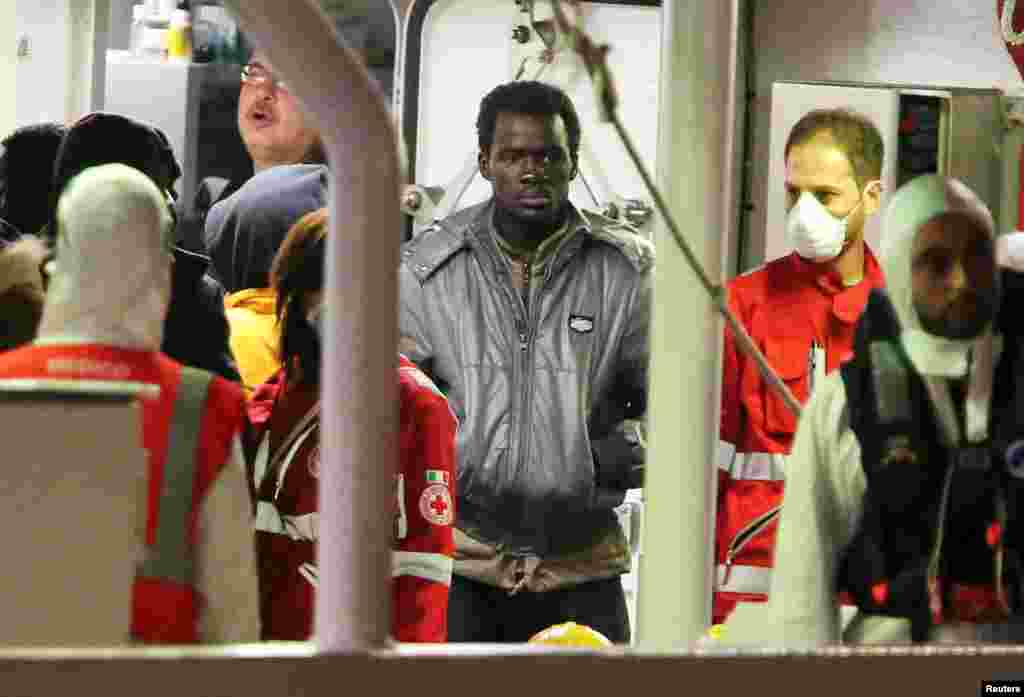 A surviving immigrant arrives by Italian Coast Guard ship Bruno Gregoretti at the port of Catania, April 21, 2015.