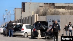 Passengers are seen after being evacuated at Mitiga airport in Tripoli, Libya, April 8, 2019. 