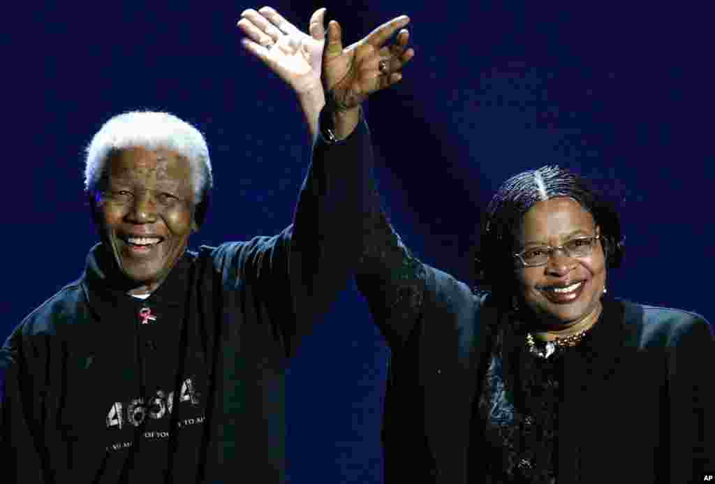 Nelson Mandela and his wife, Graca Machel, wave to the audience during a Live 8 concert in Johannesburg, July 2, 2005. 