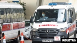 A police van carrying Stand News former editor-in-chief Chung Pui-kuen arrives at West Kowloon Magistrates' Courts, after been charged with conspiring to publish seditious material in Hong Kong, China, Dec. 30, 2021. 