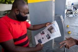 A man reads the front page of a local newspaper with the news of the assassination of President Jovenel Moise, in Port-au-Prince, Haiti, July 10, 2021.